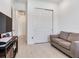 Spare living room with light hardwood flooring, a couch, and a TV with a stand at 6057 Marsh Trail Dr, Odessa, FL 33556