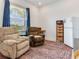 Cozy living room featuring two recliners, an area rug, and a large window at 6057 Marsh Trail Dr, Odessa, FL 33556