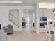 Bright, open living area featuring a staircase and integrated modern kitchen with clean lines and modern appliances at 6057 Marsh Trail Dr, Odessa, FL 33556