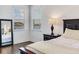 Bright main bedroom with hardwood floors, a bedside table, and a view of the water at 6057 Marsh Trail Dr, Odessa, FL 33556