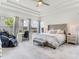 Spacious main bedroom with trey ceilings, large windows, and plush grey headboard at 6057 Marsh Trail Dr, Odessa, FL 33556