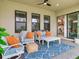 Cozy covered patio with stylish seating, a geometric rug, and views of the yard at 6057 Marsh Trail Dr, Odessa, FL 33556
