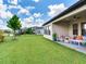 Covered patio with comfortable seating, ideal for relaxation and enjoying the backyard view at 6057 Marsh Trail Dr, Odessa, FL 33556
