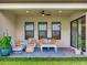 Inviting covered patio with comfortable seating, a rug, and lush green surroundings at 6057 Marsh Trail Dr, Odessa, FL 33556