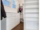 Neat walk-in closet with hardwood floors, storage shelves, and drawers at 6057 Marsh Trail Dr, Odessa, FL 33556