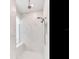 Walk-in shower with white marble tile, dual shower heads, and a built-in bench at 6057 Marsh Trail Dr, Odessa, FL 33556
