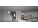 Open-concept living area with access to stairs and kitchen at 640 Allora Ave, Nokomis, FL 34275