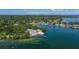 An aerial view of a waterfront community with boat ramp and lush greenery at 675 69Th S Ave, St Petersburg, FL 33712