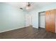 Brightly painted bedroom with a ceiling fan, closet, and wood flooring at 675 69Th S Ave, St Petersburg, FL 33712