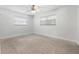 Bright bedroom featuring carpeted flooring, windows, and ceiling fan at 675 69Th S Ave, St Petersburg, FL 33712