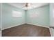 Cozy bedroom with two windows, a ceiling fan, and wood flooring at 675 69Th S Ave, St Petersburg, FL 33712