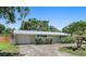 Charming single-story home featuring a metal roof, attached garage, and mature landscaping in a residential neighborhood at 675 69Th S Ave, St Petersburg, FL 33712