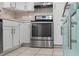 A close-up of the stainless steel oven and light colored cabinets in the kitchen at 675 69Th S Ave, St Petersburg, FL 33712