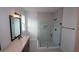 Modern bathroom featuring sleek fixtures, a glass-enclosed shower, and a spacious vanity at 699 Allora Ave, Nokomis, FL 34275
