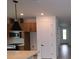 Well lit kitchen featuring modern appliances, a stylish pendant light, and white trim at 699 Allora Ave, Nokomis, FL 34275
