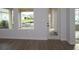 Bright living room featuring expansive windows and doors leading to the outside at 699 Allora Ave, Nokomis, FL 34275