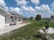 Cozy backyard featuring a patio table set and verdant lawn, great for outdoor entertaining at 702 Cypress Pl, Sun City Center, FL 33573