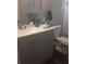 Bathroom features updated vanity with stone countertop and stylish fixtures at 702 Cypress Pl, Sun City Center, FL 33573