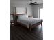 Bright bedroom with stylish flooring, a comfortable bed with blue patterned linens, and a window at 702 Cypress Pl, Sun City Center, FL 33573