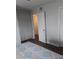 Bright bedroom featuring stylish flooring, a comfortable bed with blue patterned linens, and closet space at 702 Cypress Pl, Sun City Center, FL 33573