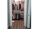 Organized closet with ample hanging space, shelving, and storage solutions for clothes and accessories at 702 Cypress Pl, Sun City Center, FL 33573