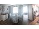 Bright dining area flows into kitchen and living space, has coastal style chairs and decor at 702 Cypress Pl, Sun City Center, FL 33573