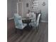 A charming dining area features a round table and four stylishly upholstered chairs at 702 Cypress Pl, Sun City Center, FL 33573
