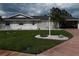 Charming single-story home with well-maintained lawn, mature palm trees, and an attached garage at 702 Cypress Pl, Sun City Center, FL 33573