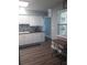 Updated kitchen features white cabinets, stylish backsplash, and stainless steel appliances at 702 Cypress Pl, Sun City Center, FL 33573