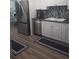 Bright kitchen features stainless steel appliances, white cabinets, and a complementary backsplash at 702 Cypress Pl, Sun City Center, FL 33573