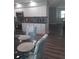 Open kitchen with white cabinets, stylish backsplash, and modern stainless steel appliances at 702 Cypress Pl, Sun City Center, FL 33573