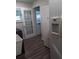 Bright laundry room featuring a refrigerator, exterior door, utility sink, and dark wood flooring at 702 Cypress Pl, Sun City Center, FL 33573