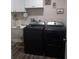 Laundry room featuring a utility sink, stainless steel washer and dryer set, and laundry themed decor at 702 Cypress Pl, Sun City Center, FL 33573