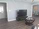 Open-concept living area featuring a TV, console table and coffee table at 702 Cypress Pl, Sun City Center, FL 33573
