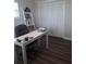 Bright office space with wood floors, closet, ladder shelf, and white modern desk at 702 Cypress Pl, Sun City Center, FL 33573