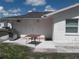 Outdoor patio with a grill, table, and privacy fencing; perfect for entertaining guests at 702 Cypress Pl, Sun City Center, FL 33573