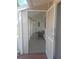 Inviting screened-in porch features a bench, tiled floor, and view of the front door at 702 Cypress Pl, Sun City Center, FL 33573