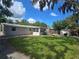Expansive backyard featuring a well-maintained lawn, mature trees, storage shed, and plenty of space for outdoor activities at 7427 Banner St, New Port Richey, FL 34653