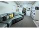 Cozy basement featuring a comfortable seating area, washer/dryer, and storage, offering versatile living and utility space at 7427 Banner St, New Port Richey, FL 34653