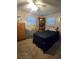 Well-lit bedroom with a cozy bed, dresser, and chair, perfect for relaxation and rest at 7427 Banner St, New Port Richey, FL 34653