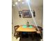 Cozy dining area featuring a wooden table set for four, with decorative wall art at 7427 Banner St, New Port Richey, FL 34653