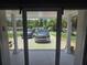 View from inside featuring two vehicles in the driveway, with a pleasant glimpse of the outdoors at 7427 Banner St, New Port Richey, FL 34653