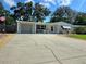 Single Gathering home with a long driveway and garage on a sunny day at 7427 Banner St, New Port Richey, FL 34653