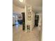 Welcoming foyer with neutral tiles, decor and view into the living room, and an open kitchen at 7427 Banner St, New Port Richey, FL 34653