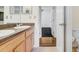 Bright bathroom featuring double sinks with wood cabinets and granite countertops at 7515 Dragon Fly Loop, Gibsonton, FL 33534