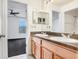 Bright bathroom with double sinks with wood cabinets and granite countertops at 7515 Dragon Fly Loop, Gibsonton, FL 33534