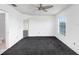 Spacious bedroom featuring a ceiling fan, a window, and dark carpet at 7515 Dragon Fly Loop, Gibsonton, FL 33534