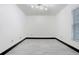 Empty bedroom with white walls, tile flooring, and natural light from the window at 7515 Dragon Fly Loop, Gibsonton, FL 33534