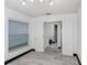Bedroom with window, white walls, and double doors to the ensuite bathroom at 7515 Dragon Fly Loop, Gibsonton, FL 33534