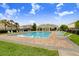 Community pool with lounge chairs, a covered pavilion, and well-maintained brick decking and landscaping at 7515 Dragon Fly Loop, Gibsonton, FL 33534